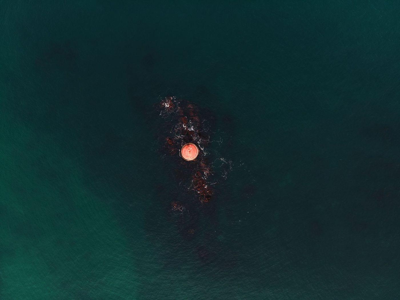 An instrumented monitoring buoy riding a light swell in open water